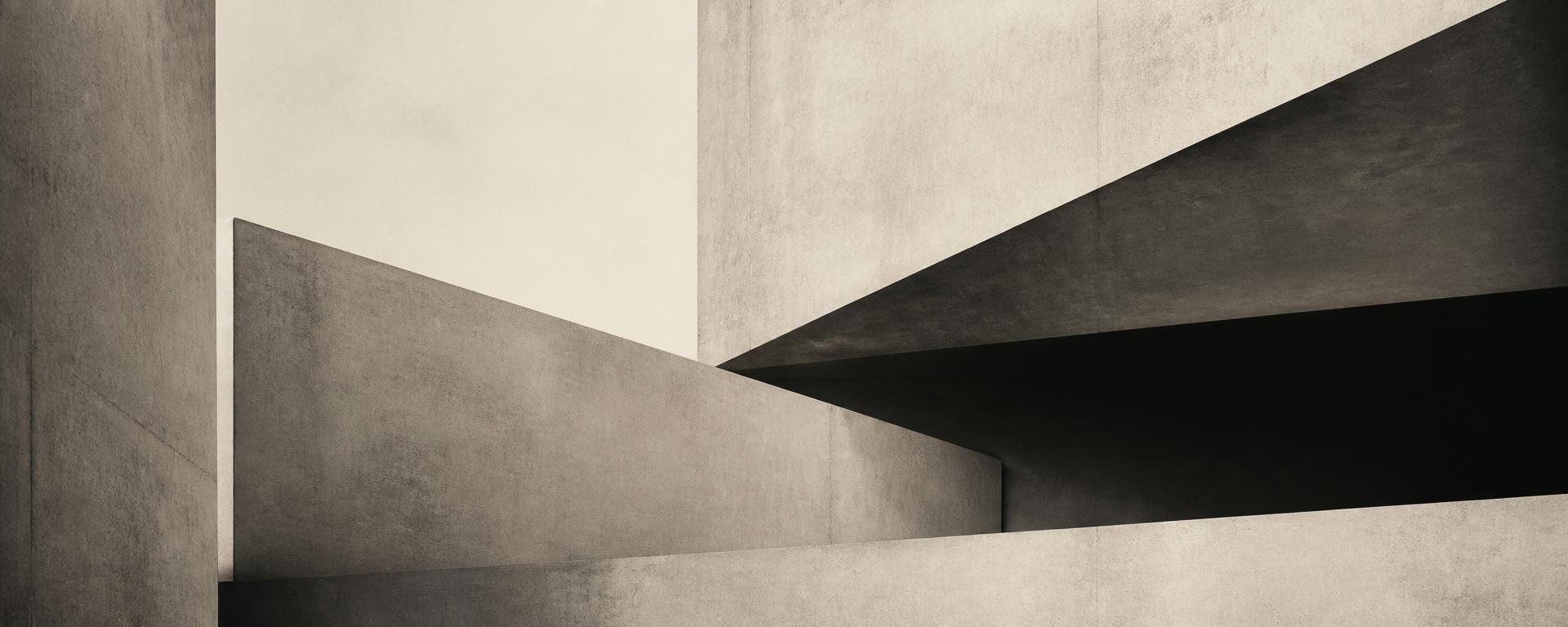 Abstract composition of layered concrete planes and industrial geometric forms